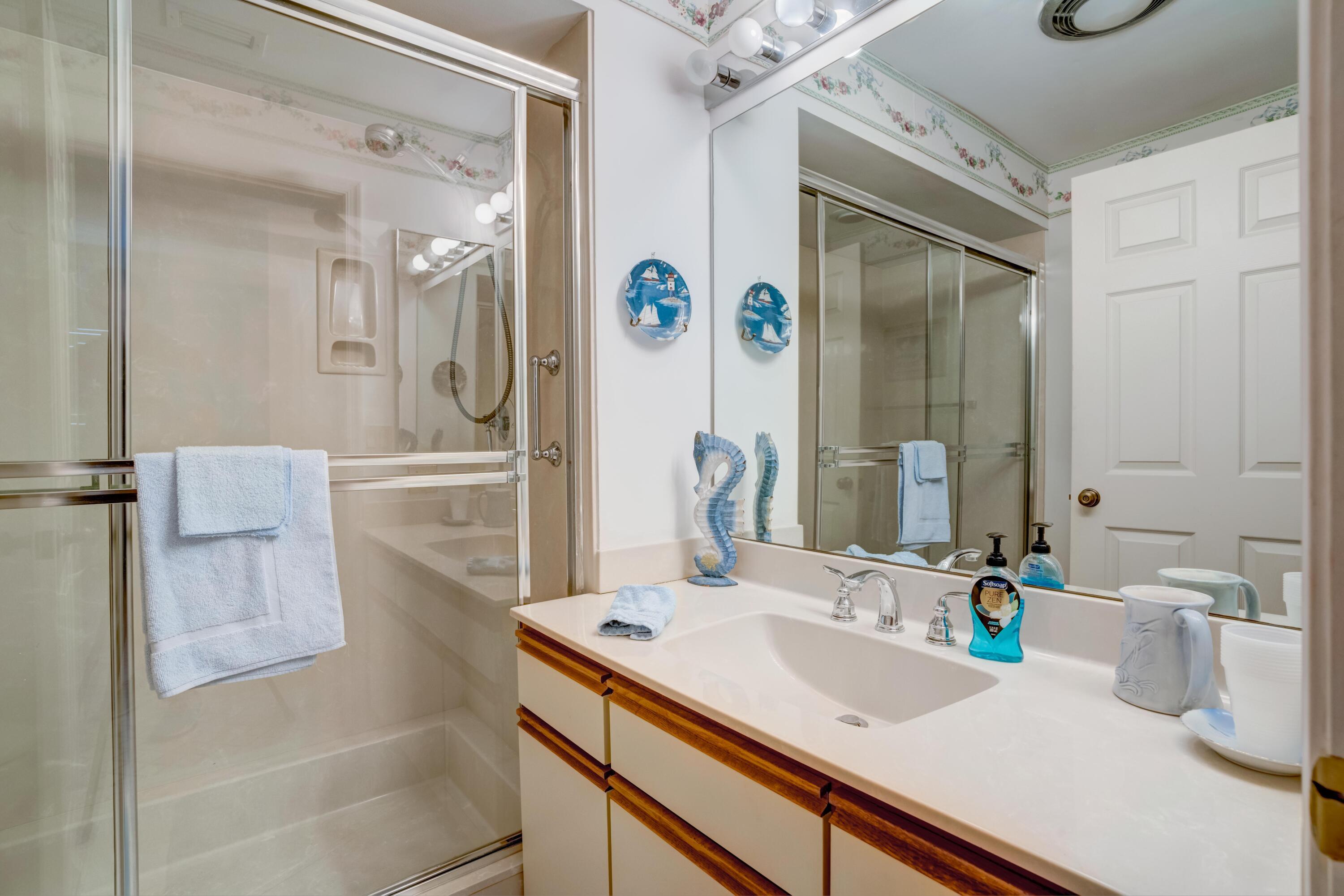 3518 Lantern Bay Drive Jupiter, FL 33477 - Photo 9 of 32 a bathroom with a sink and a mirror