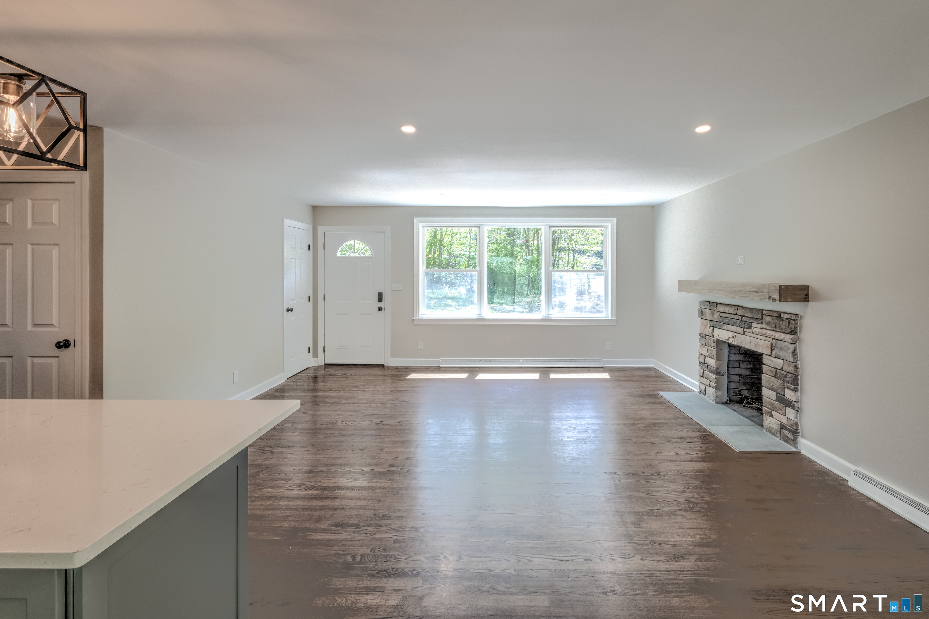 437 Middle Rd Turnpike Woodbury, CT 06798 - Photo 5 of 17 a view of empty room with wooden floor and fireplace