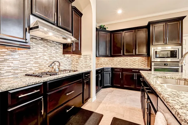 a kitchen with stainless steel appliances granite countertop a stove and a sink
