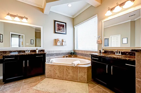 a bathroom with a bathtub and a mirror