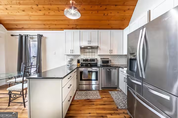 68 Franklin Road Eatonton, GA 31024 - Photo 12 of 28 a kitchen with stainless steel appliances granite countertop a stove and a refrigerator