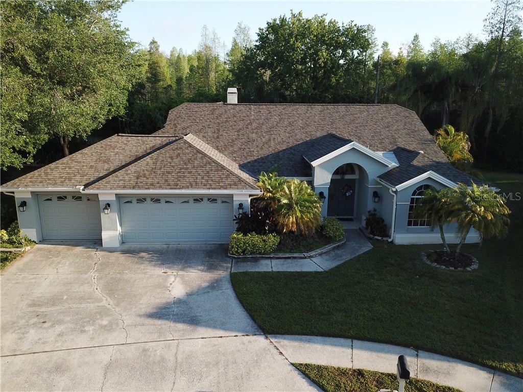 7025 Fallbrook Court New Port Richey, FL 34655 - Photo 1 of 1 a view of a house with a yard and a garden