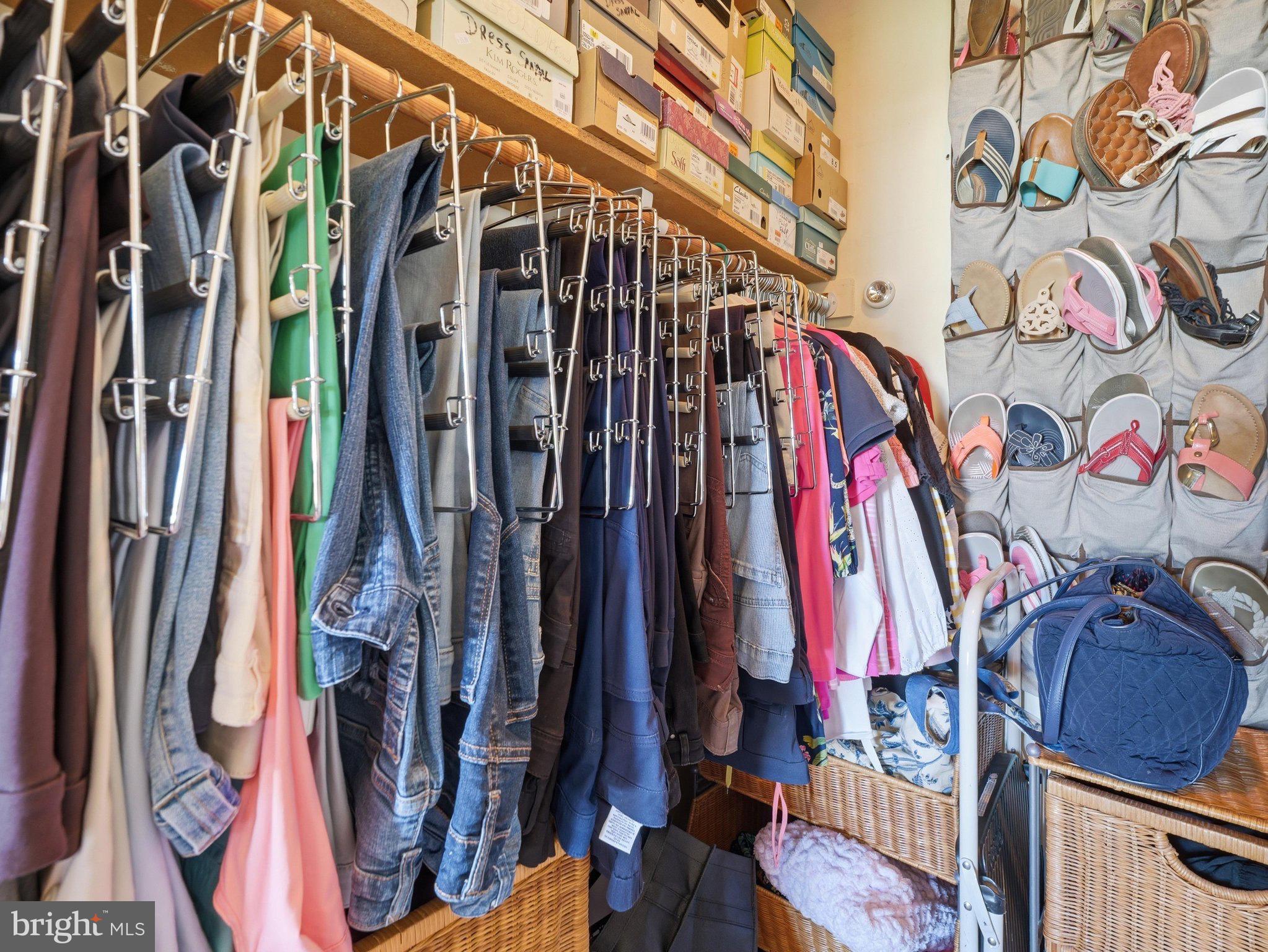 2606 Ridge Road South Martinsburg, WV 25403 - Photo 29 of 57 Organized closet with vibrant clothing display.