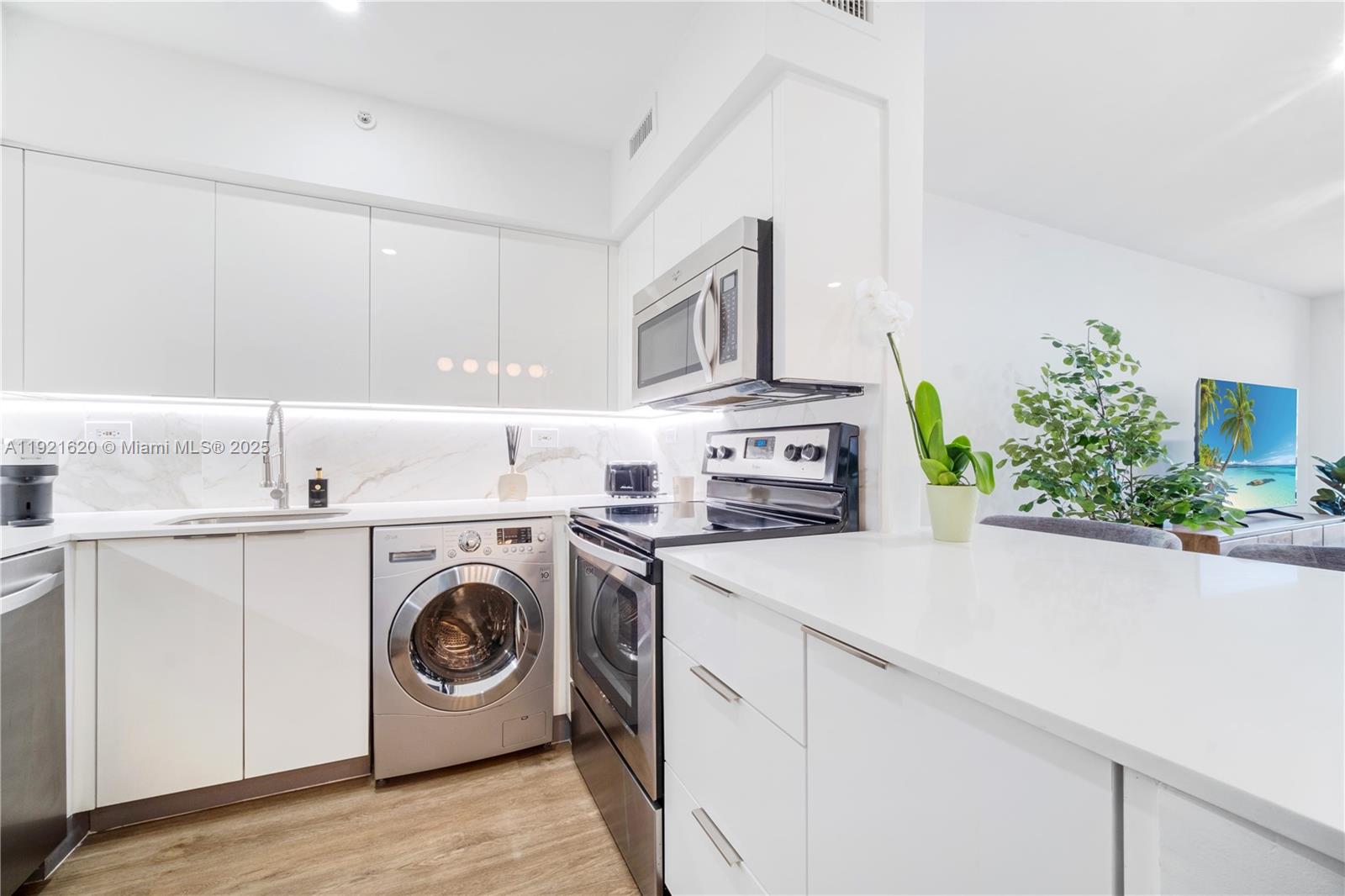 1500 Bay Road, Unit 1558S Miami Beach, FL 33139 - Photo 12 of 54 a utility room with sink dryer and washer