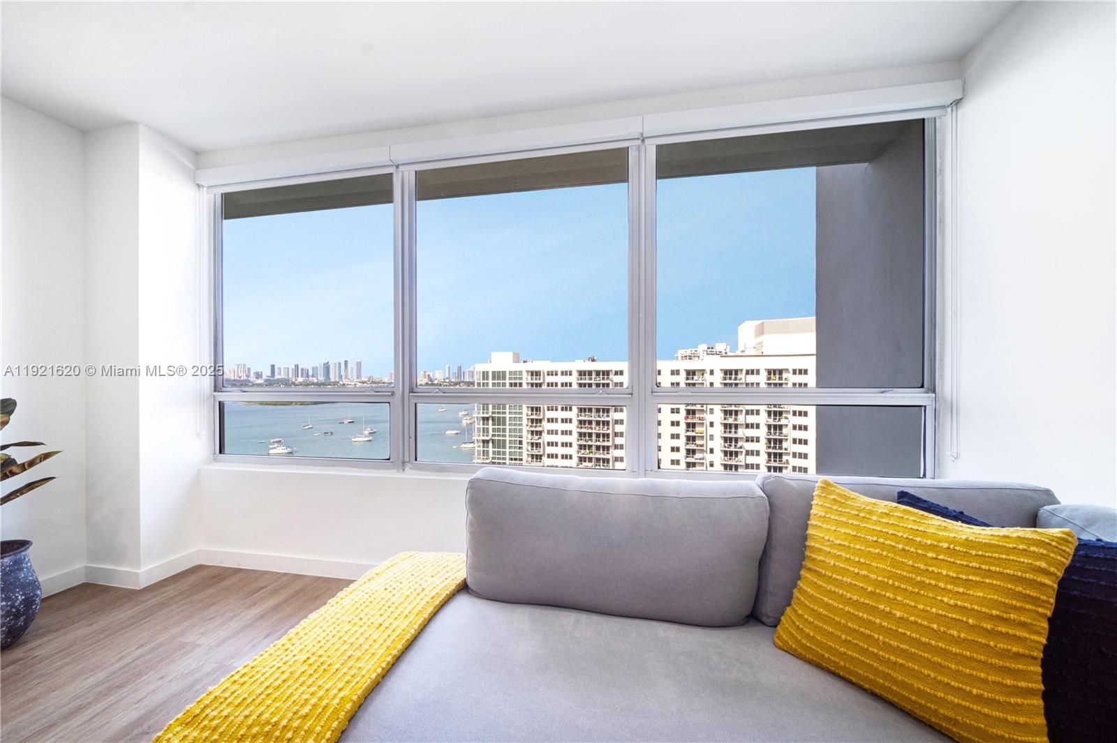 1500 Bay Road, Unit 1558S Miami Beach, FL 33139 - Photo 14 of 54 a living room with a bed and a couch