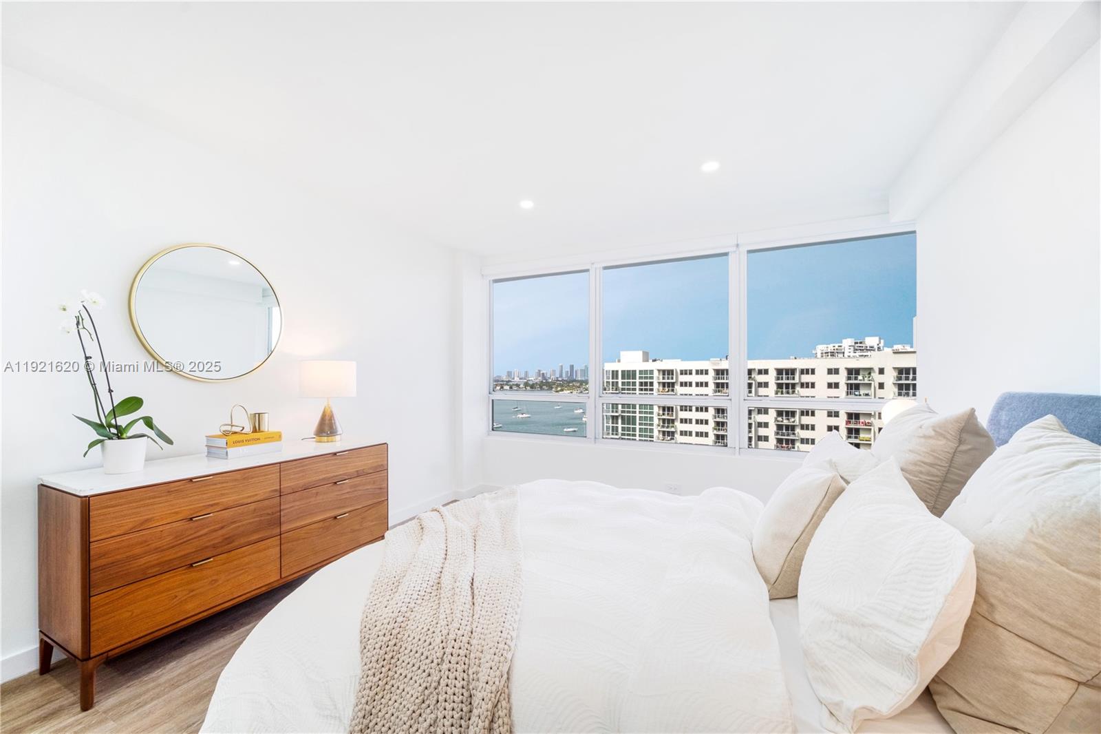 1500 Bay Road, Unit 1558S Miami Beach, FL 33139 - Photo 20 of 54 a bedroom with a bed mirror and a window