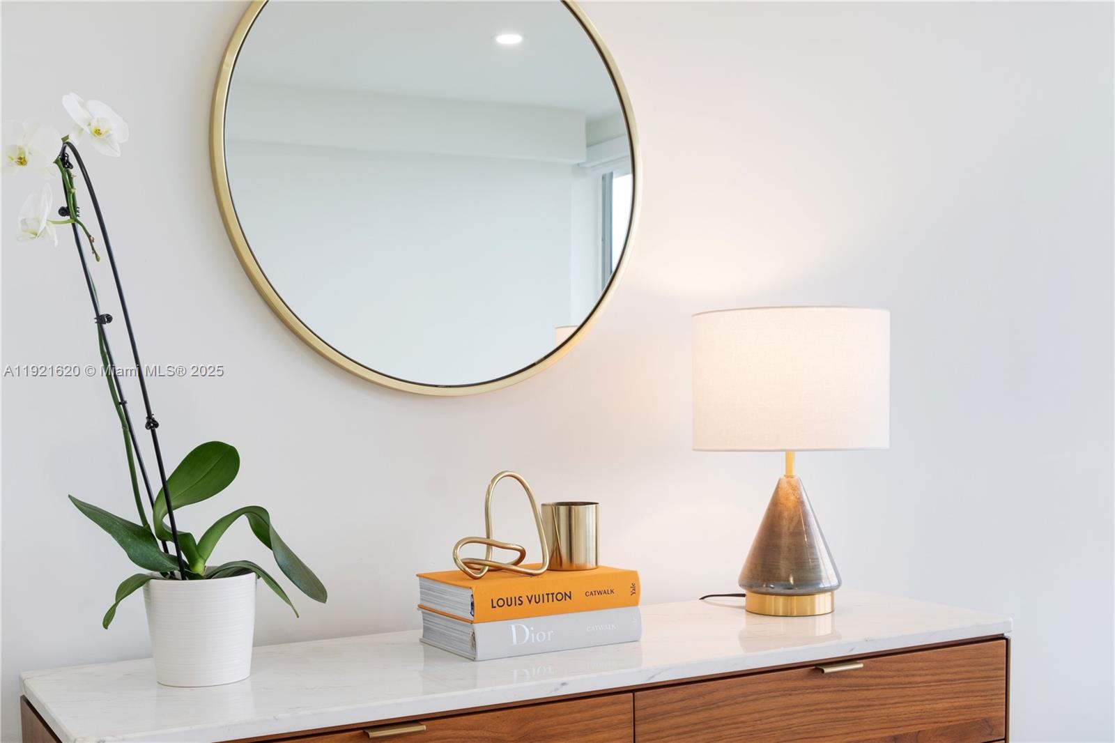 1500 Bay Road, Unit 1558S Miami Beach, FL 33139 - Photo 21 of 54 a bathroom with a sink a mirror and a potted plant