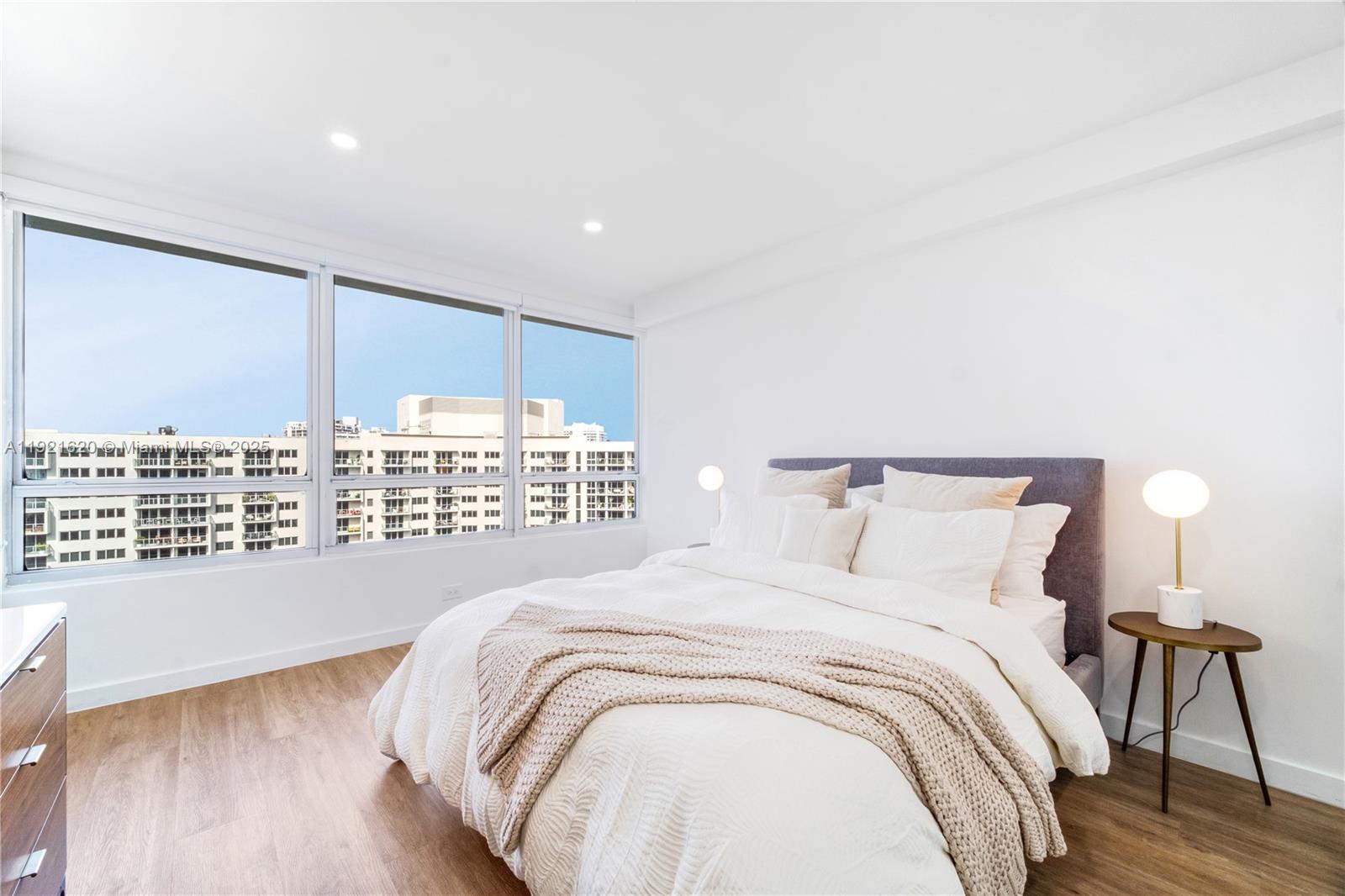1500 Bay Road, Unit 1558S Miami Beach, FL 33139 - Photo 22 of 54 a large bed sitting in a bedroom next to a window