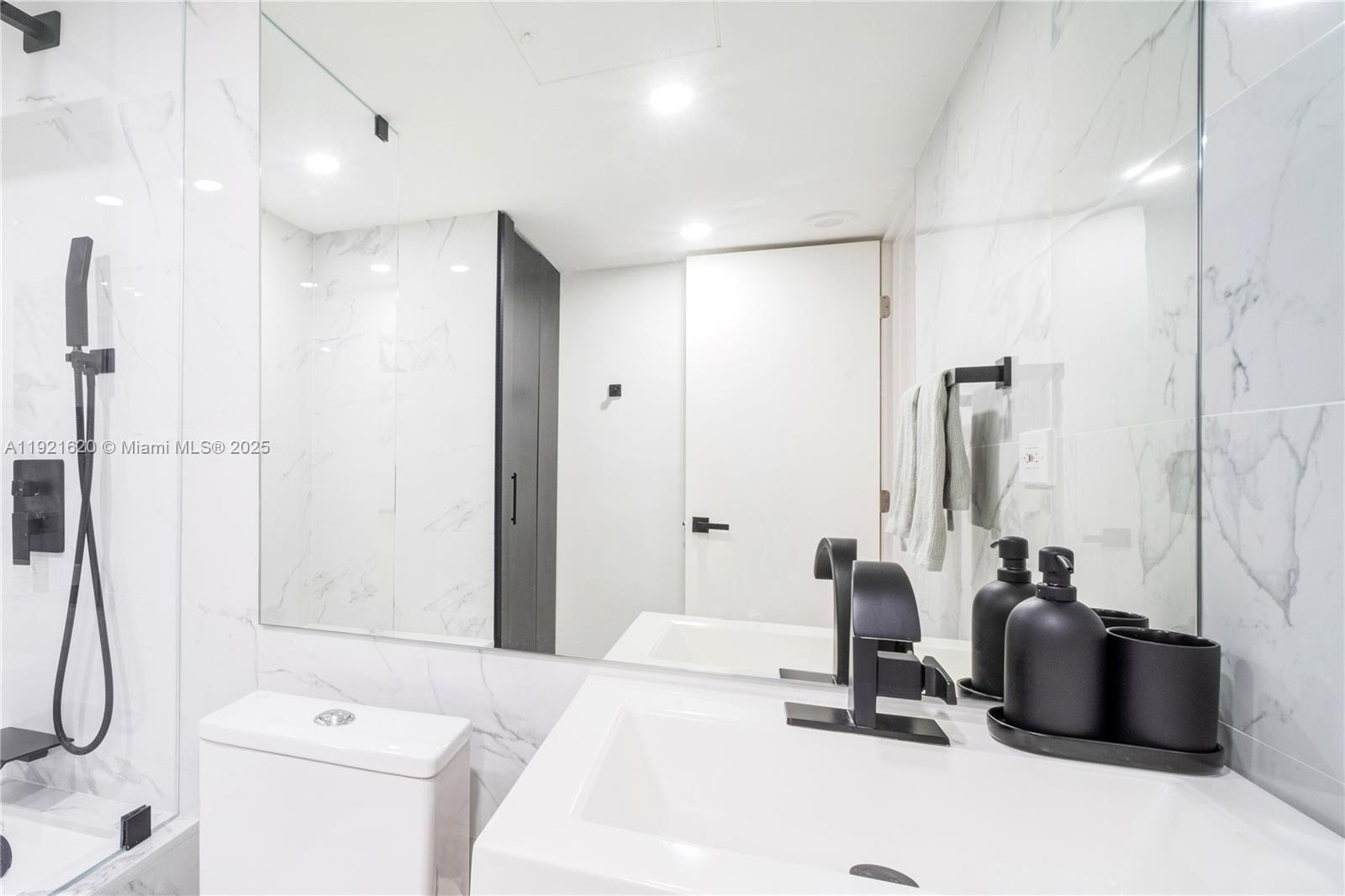 1500 Bay Road, Unit 1558S Miami Beach, FL 33139 - Photo 27 of 54 a bathroom with a double sink and a mirror