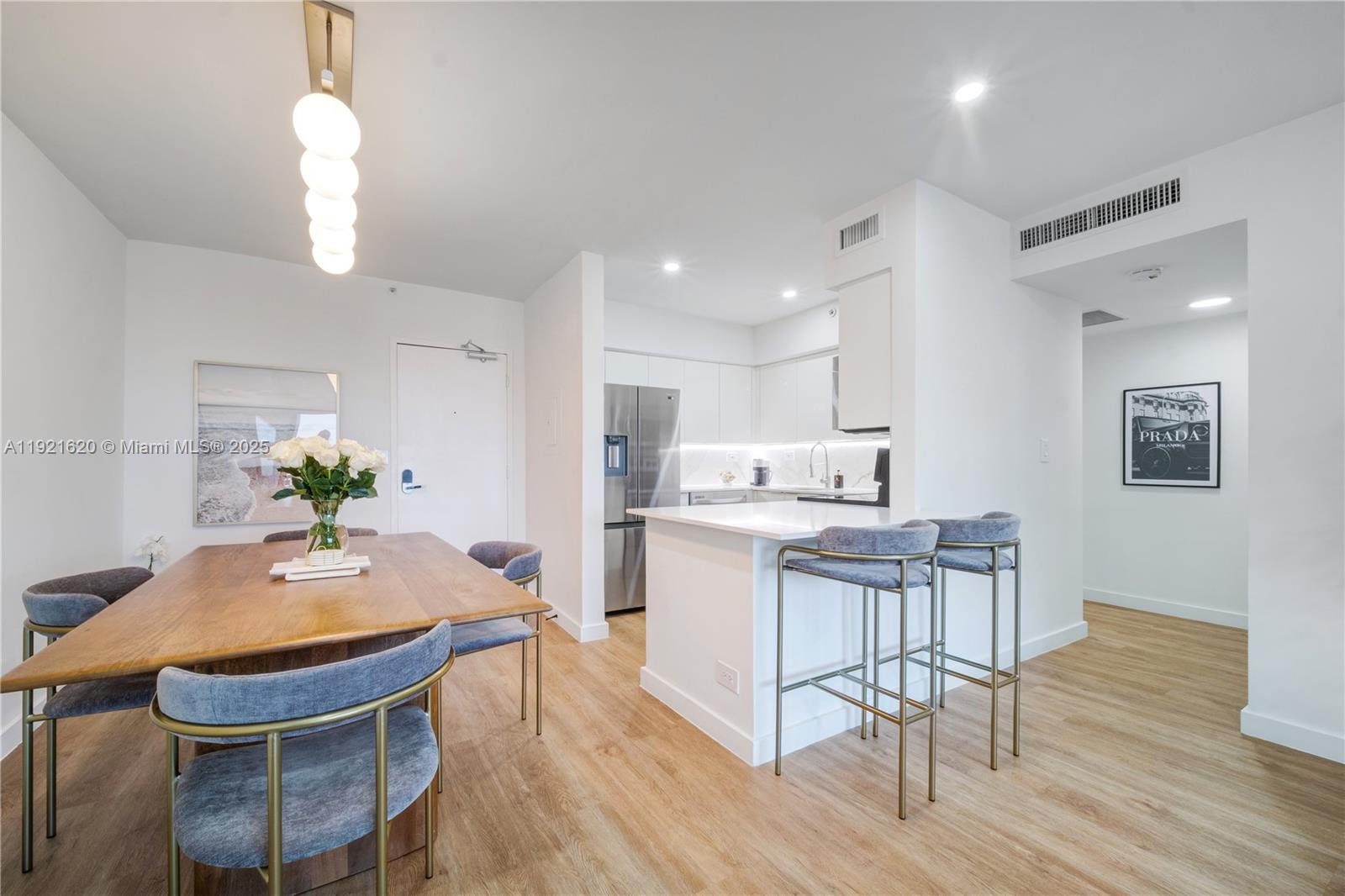 1500 Bay Road, Unit 1558S Miami Beach, FL 33139 - Photo 5 of 54 a dining room with kitchen island a table and chairs
