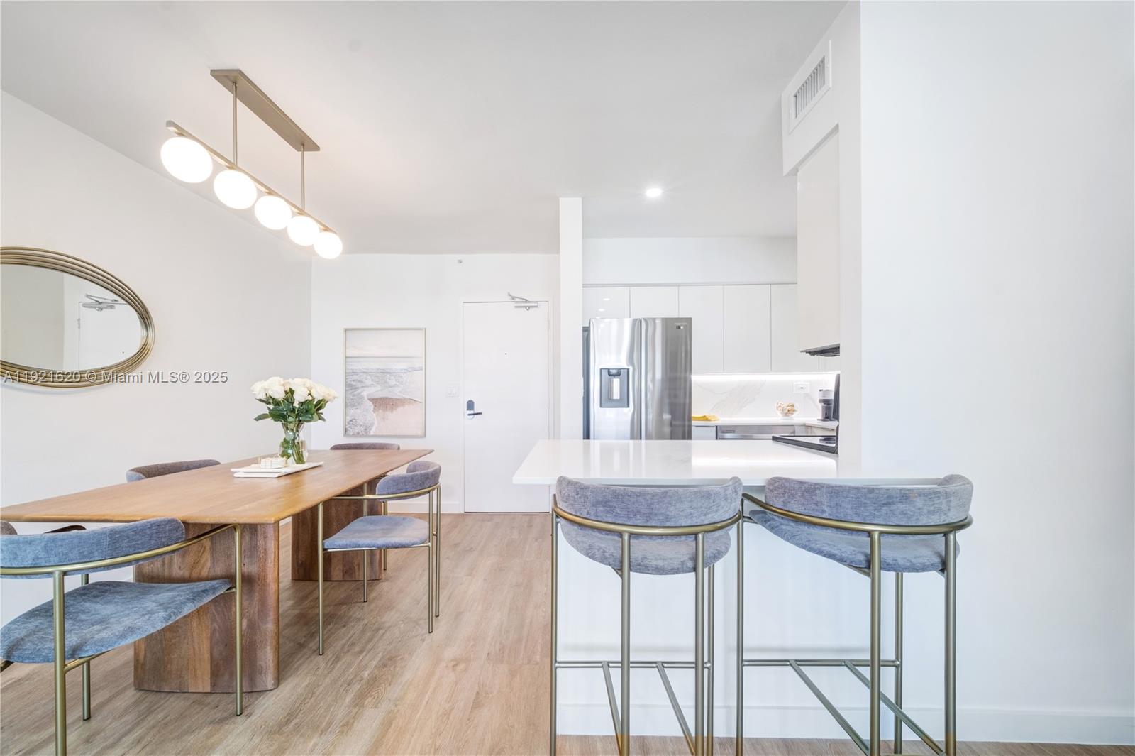 1500 Bay Road, Unit 1558S Miami Beach, FL 33139 - Photo 6 of 54 a view of a dining room with furniture and wooden floor