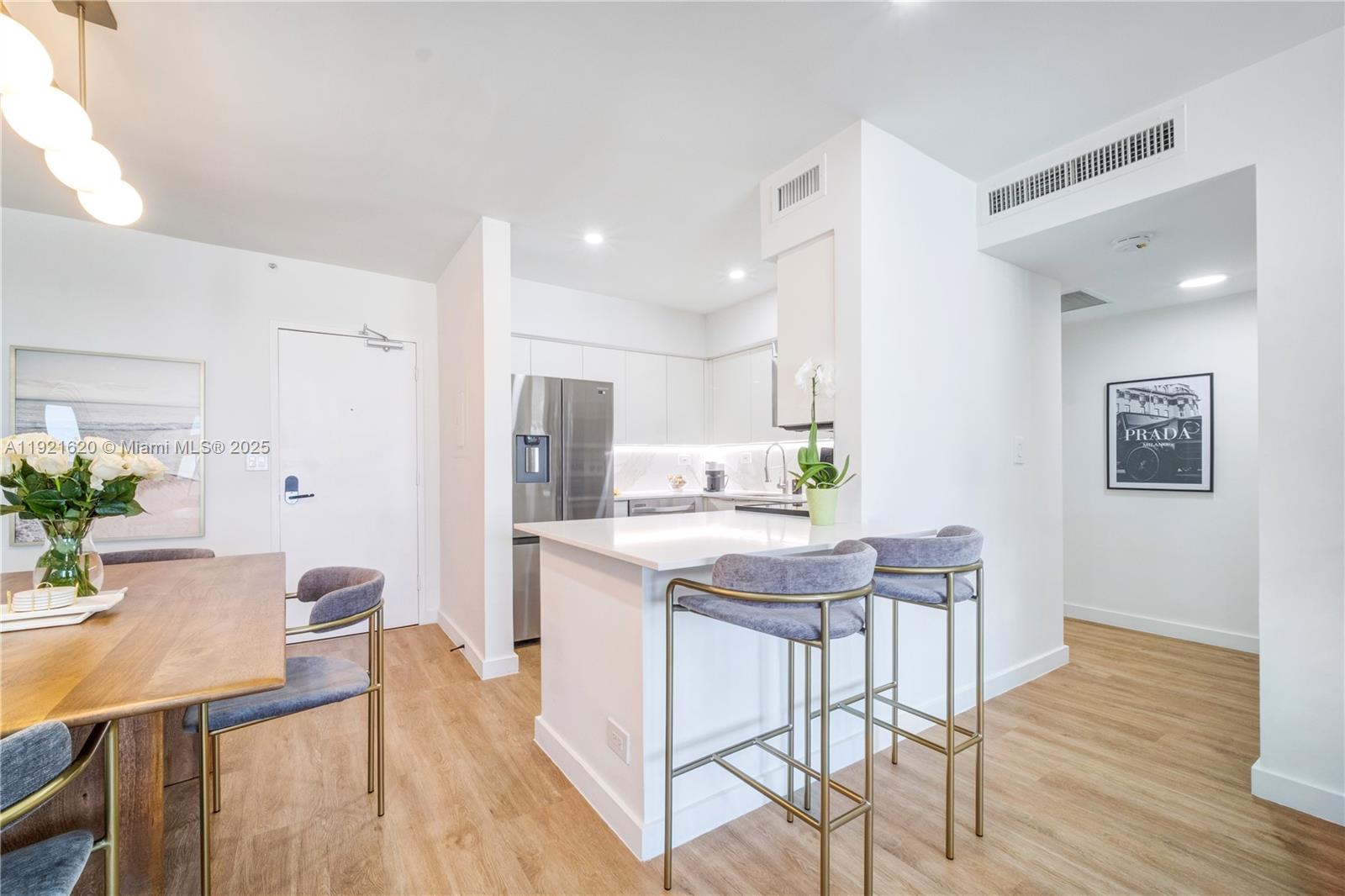 1500 Bay Road, Unit 1558S Miami Beach, FL 33139 - Photo 7 of 54 a view of a dining room with furniture and wooden floor