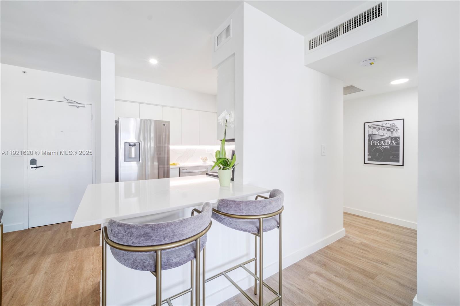 1500 Bay Road, Unit 1558S Miami Beach, FL 33139 - Photo 8 of 54 a view of a dining room with furniture and wooden floor