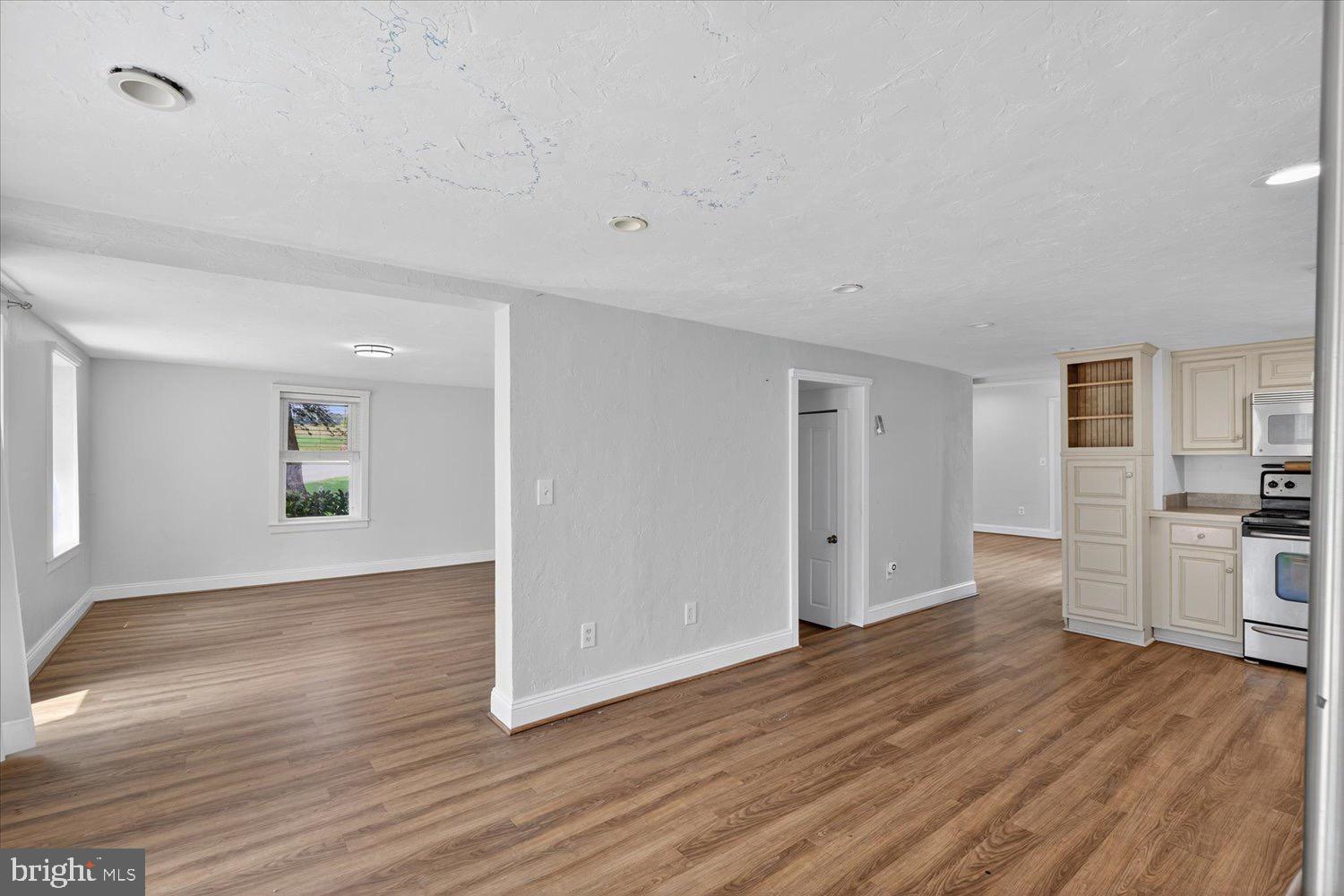 5605 Waltersdorff Road Spring Grove, PA 17362 - Photo 16 of 40 a view of a kitchen and an empty room with wooden floor