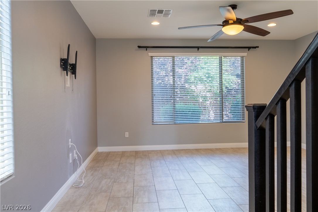 11045 Elk Sands Road Las Vegas, NV 89179 - Photo 48 of 67 Tiled floors and recessed lighting enhance this versatile living space next to the staircase.