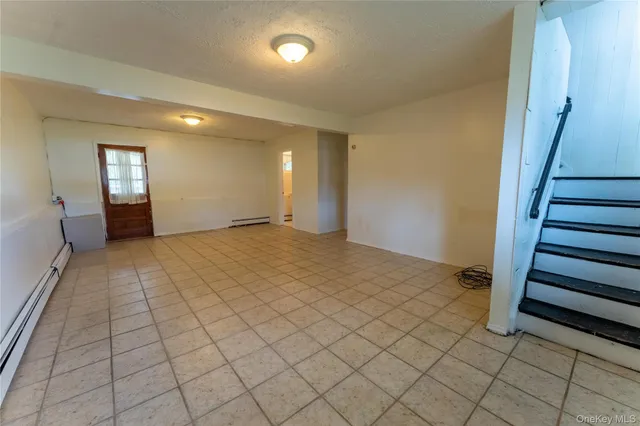 a view of an empty room and stairs