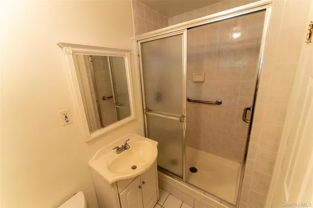 a bathroom with a shower and a sink