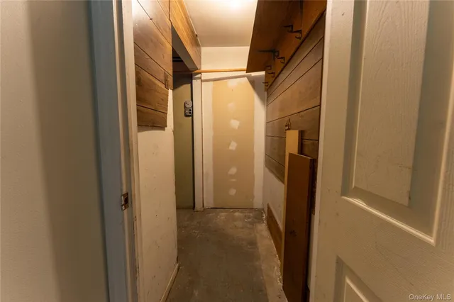 a view of hallway with stainless steel appliances granite countertop and a refrigerator