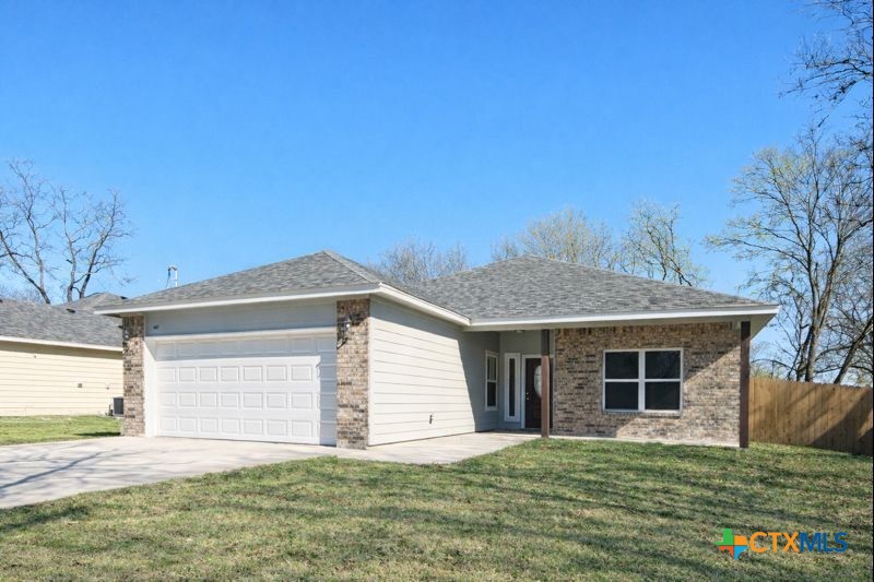 407 Gamel Street Lampasas, TX 76550 - Photo 1 of 20 a front view of a house with a garden