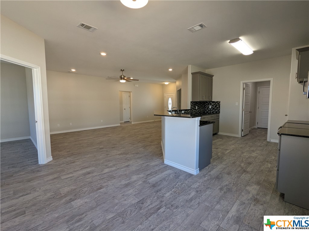 407 Gamel Street Lampasas, TX 76550 - Photo 11 of 20 a kitchen with granite countertop a stove and a refrigerator