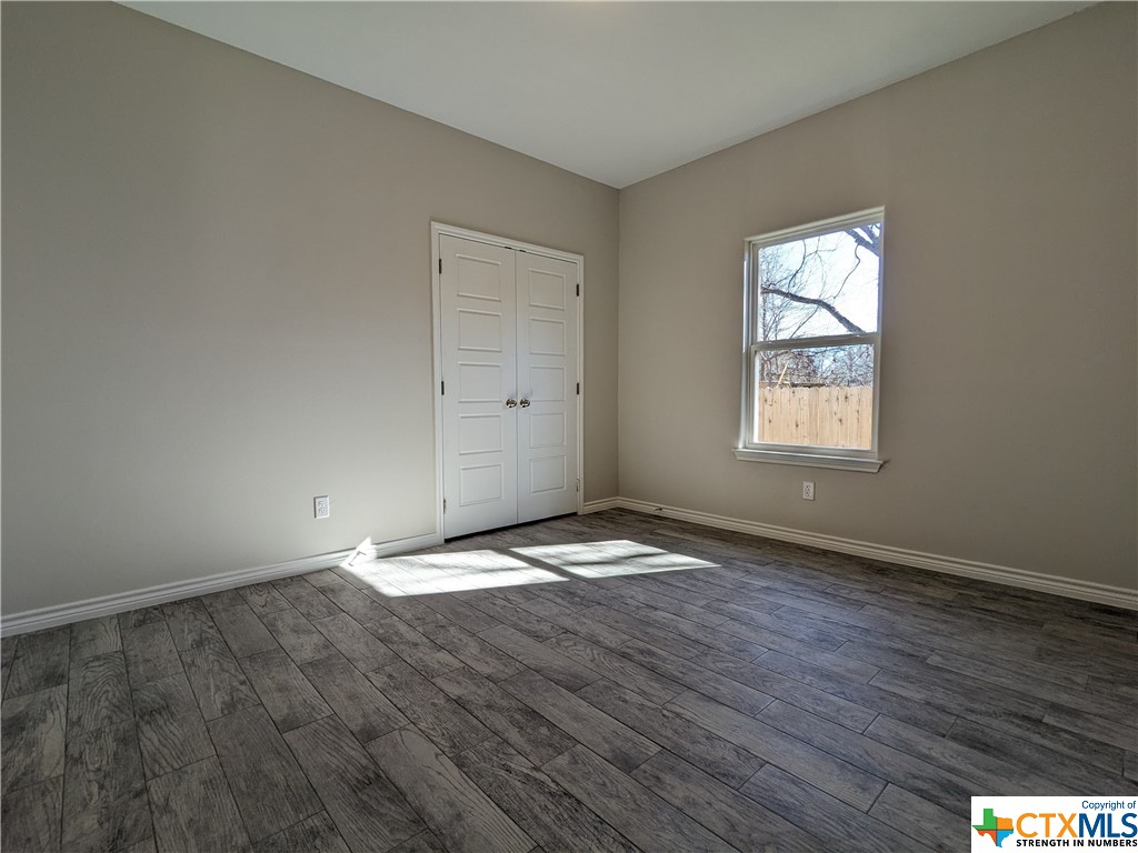 407 Gamel Street Lampasas, TX 76550 - Photo 20 of 20 an empty room with wooden floor and windows