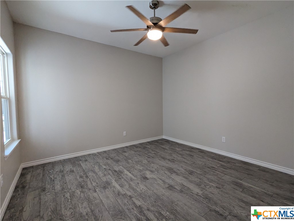 407 Gamel Street Lampasas, TX 76550 - Photo 5 of 20 wooden floor in an empty room with a window