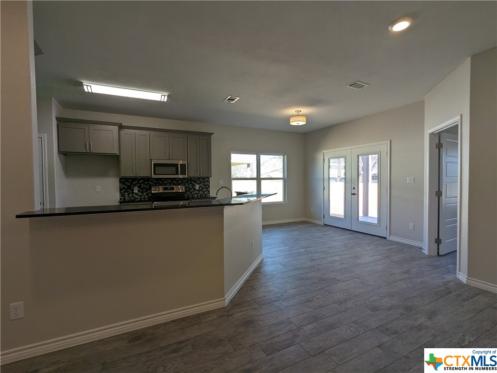 407 Gamel Street Lampasas, TX 76550 - Photo 6 of 20 a kitchen with stainless steel appliances a refrigerator sink and cabinets