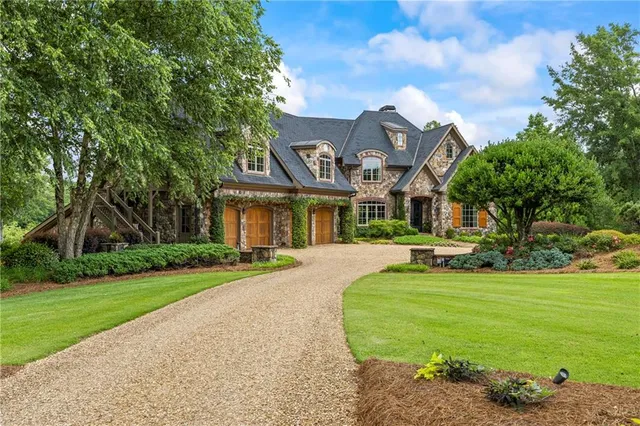 a front view of a house with a garden
