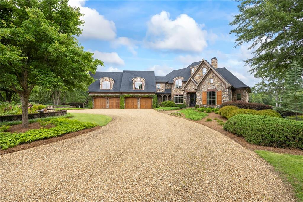 4239 Lower Jersey Road Covington, GA 30014 - Photo 35 of 91 a front view of a house with a yard and garage