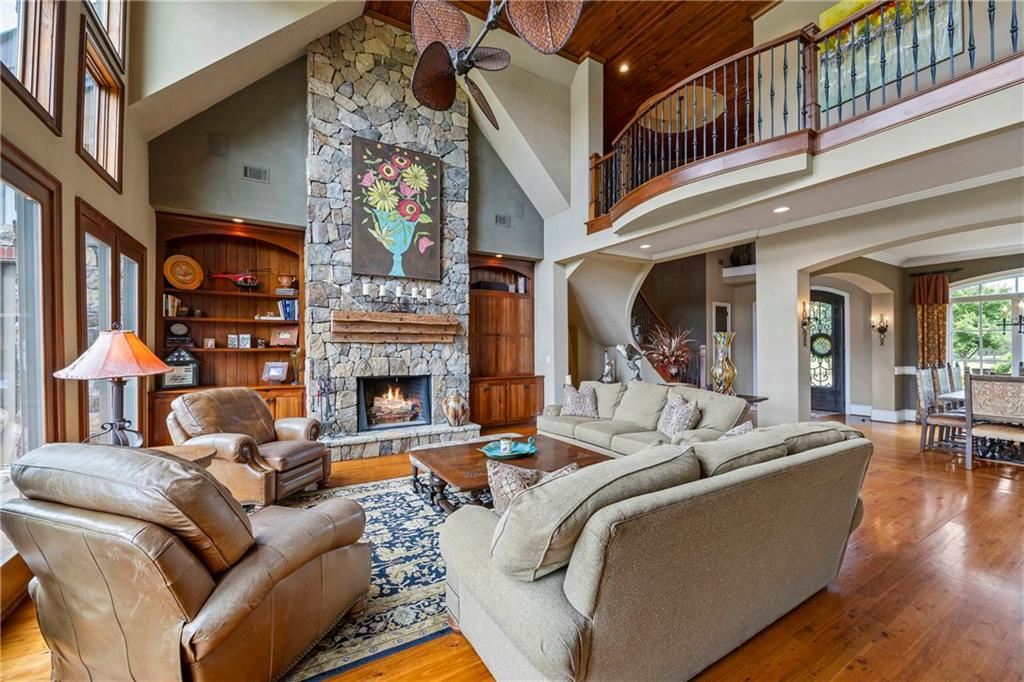 4239 Lower Jersey Road Covington, GA 30014 - Photo 49 of 91 a living room with furniture a fireplace and a chandelier