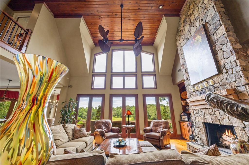 4239 Lower Jersey Road Covington, GA 30014 - Photo 51 of 91 a living room with furniture a fireplace and a floor to ceiling window