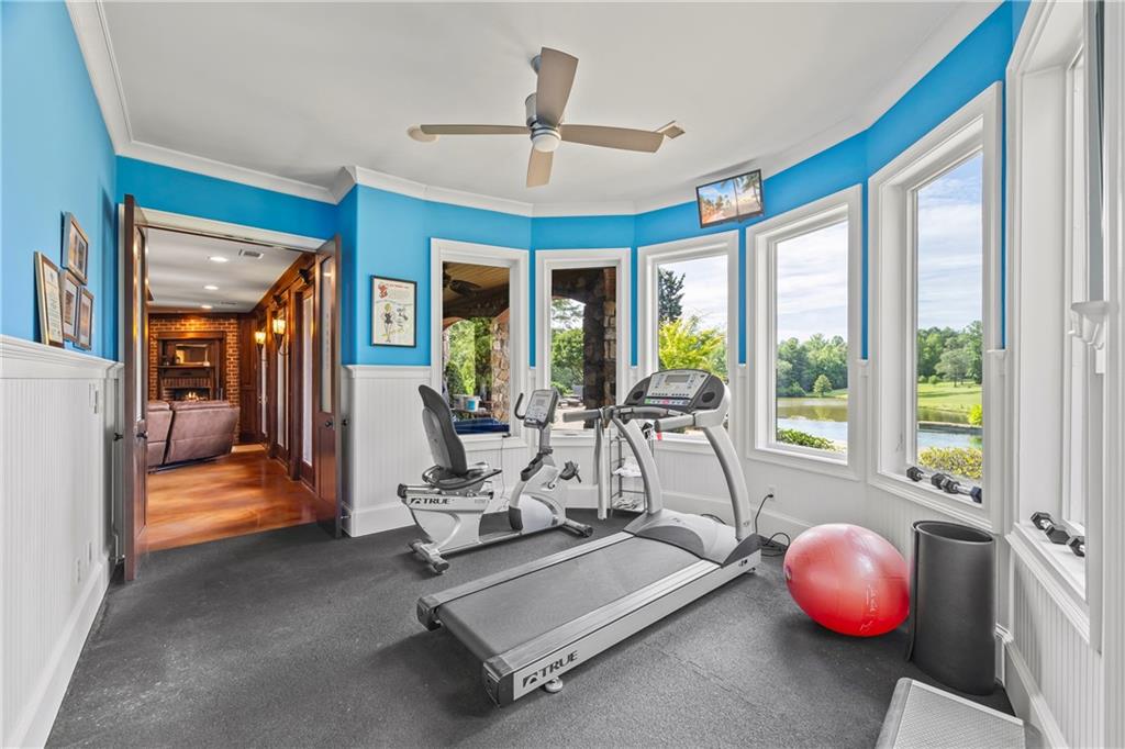 4239 Lower Jersey Road Covington, GA 30014 - Photo 84 of 91 a room with gym equipment and large windows