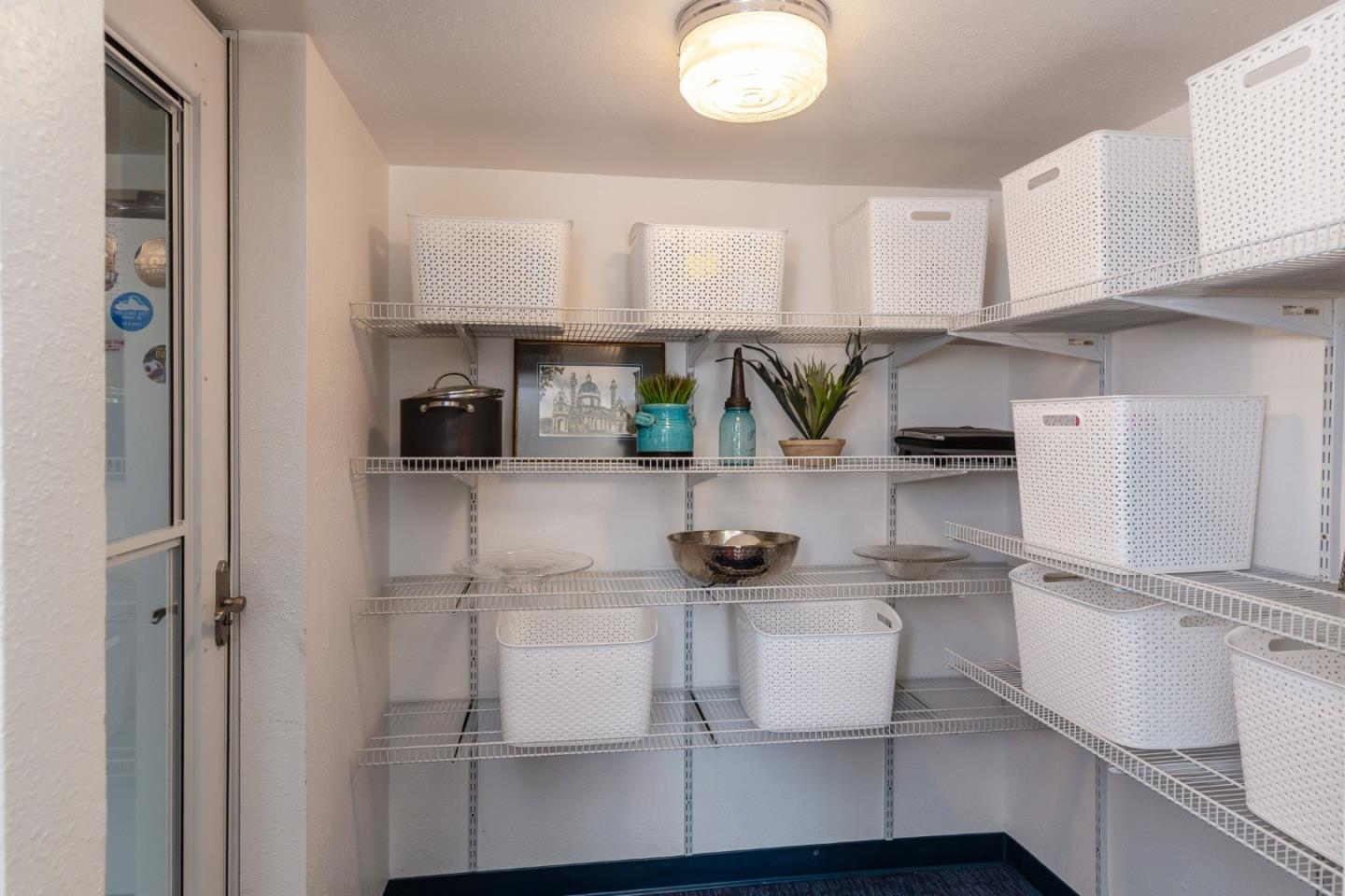180 Maricopa Drive Los Gatos, CA 95032 - Photo 11 of 14 a kitchen with a refrigerator and white cabinets