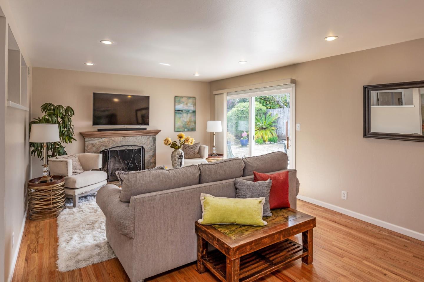 180 Maricopa Drive Los Gatos, CA 95032 - Photo 2 of 14 a living room with furniture a flat screen tv and a fireplace