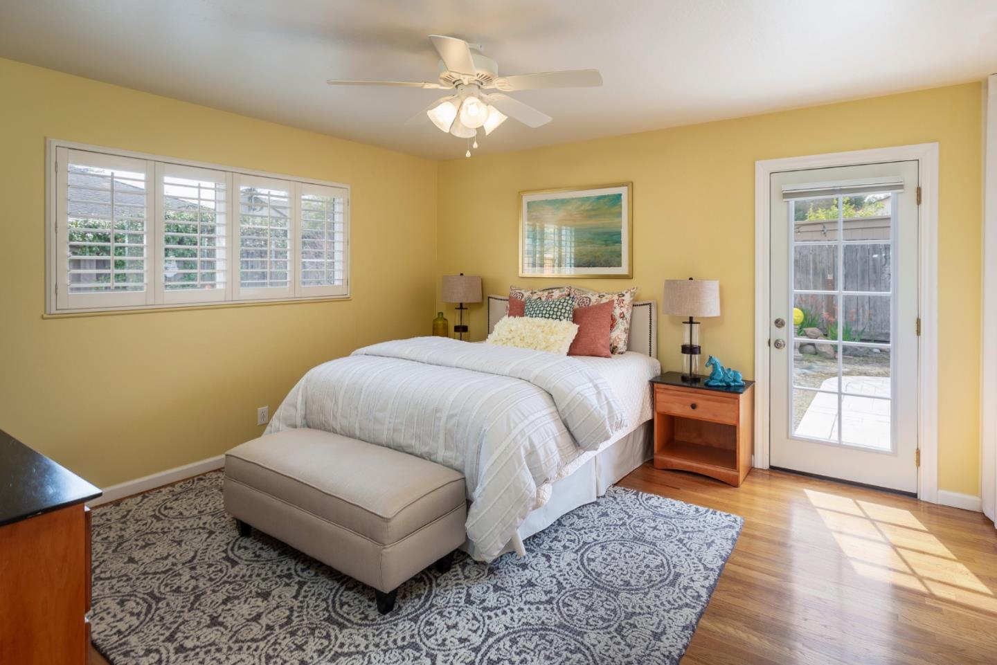 180 Maricopa Drive Los Gatos, CA 95032 - Photo 7 of 14 a bedroom with a bed lamps and wooden floor
