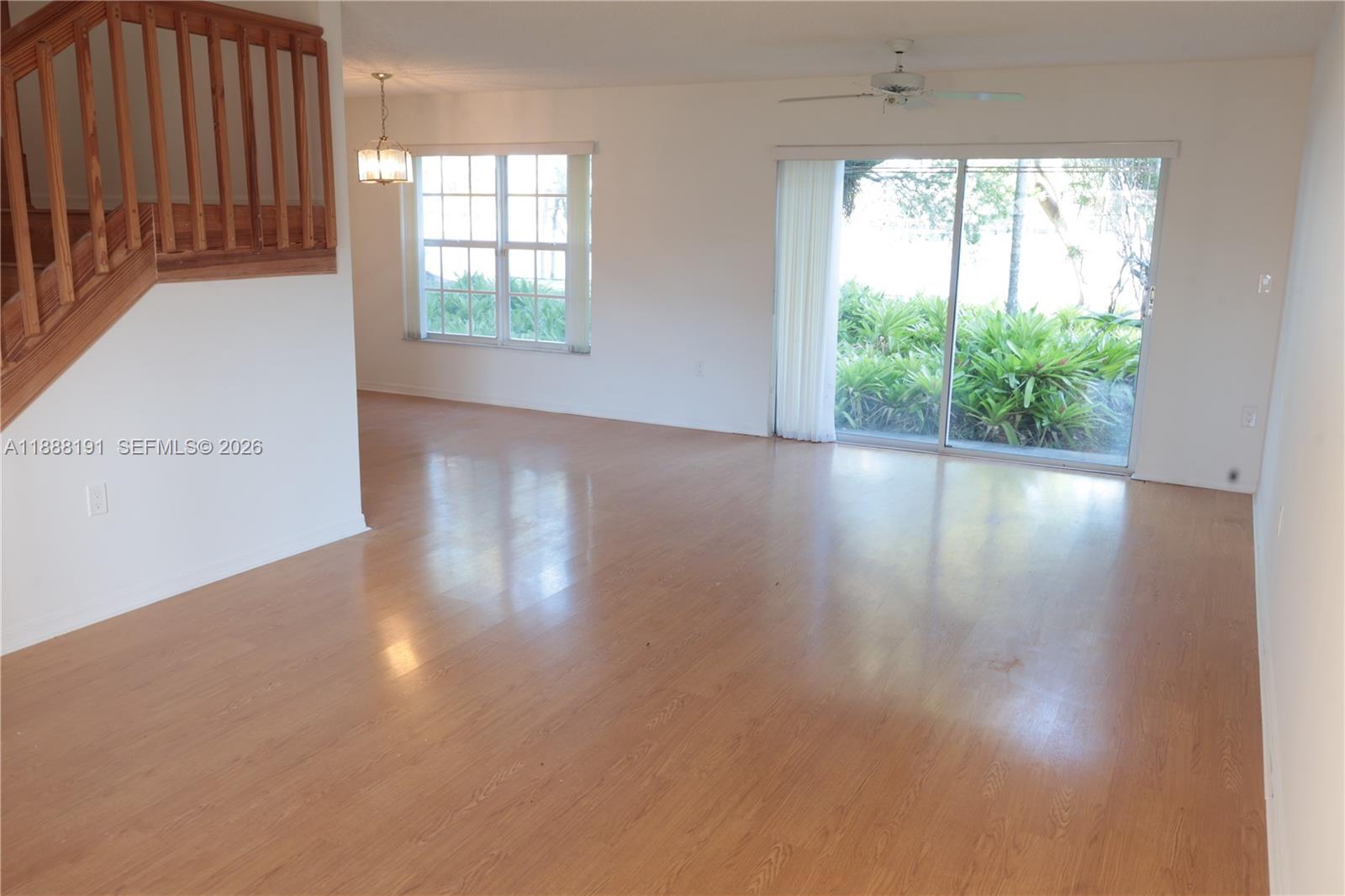 10889 Southwest 149th Place Miami, FL 33196 - Photo 13 of 51 an empty room with wooden floor and windows
