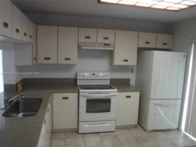 a view of wooden floor and utility room in a house