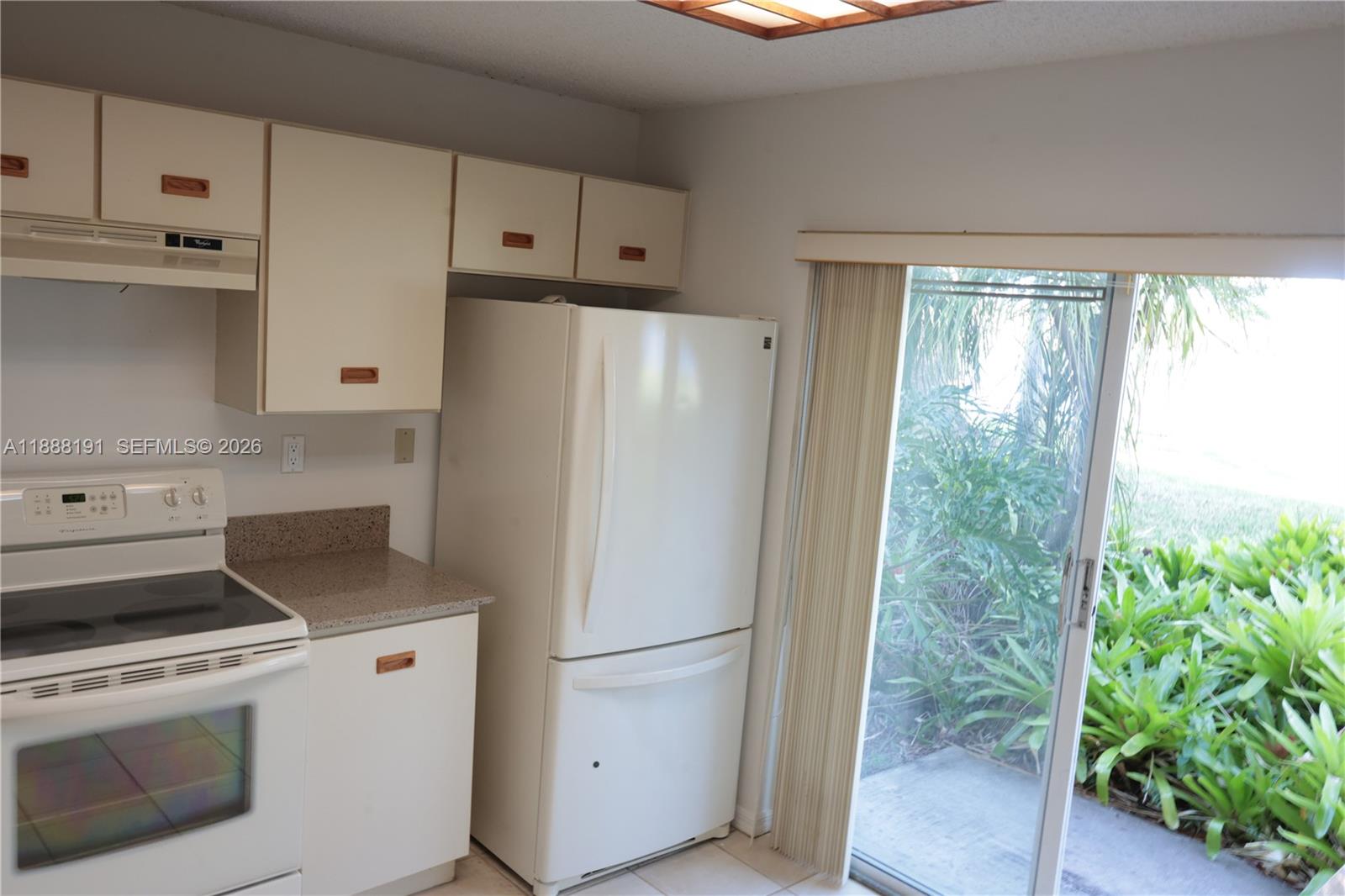 10889 Southwest 149th Place Miami, FL 33196 - Photo 16 of 51 a white refrigerator freezer sitting inside of a kitchen