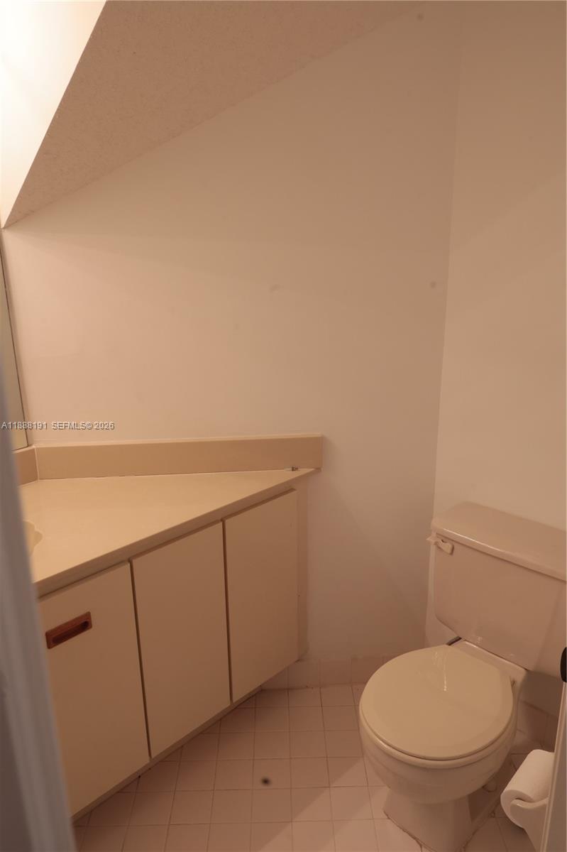 10889 Southwest 149th Place Miami, FL 33196 - Photo 20 of 51 a bathroom with a toilet and a sink