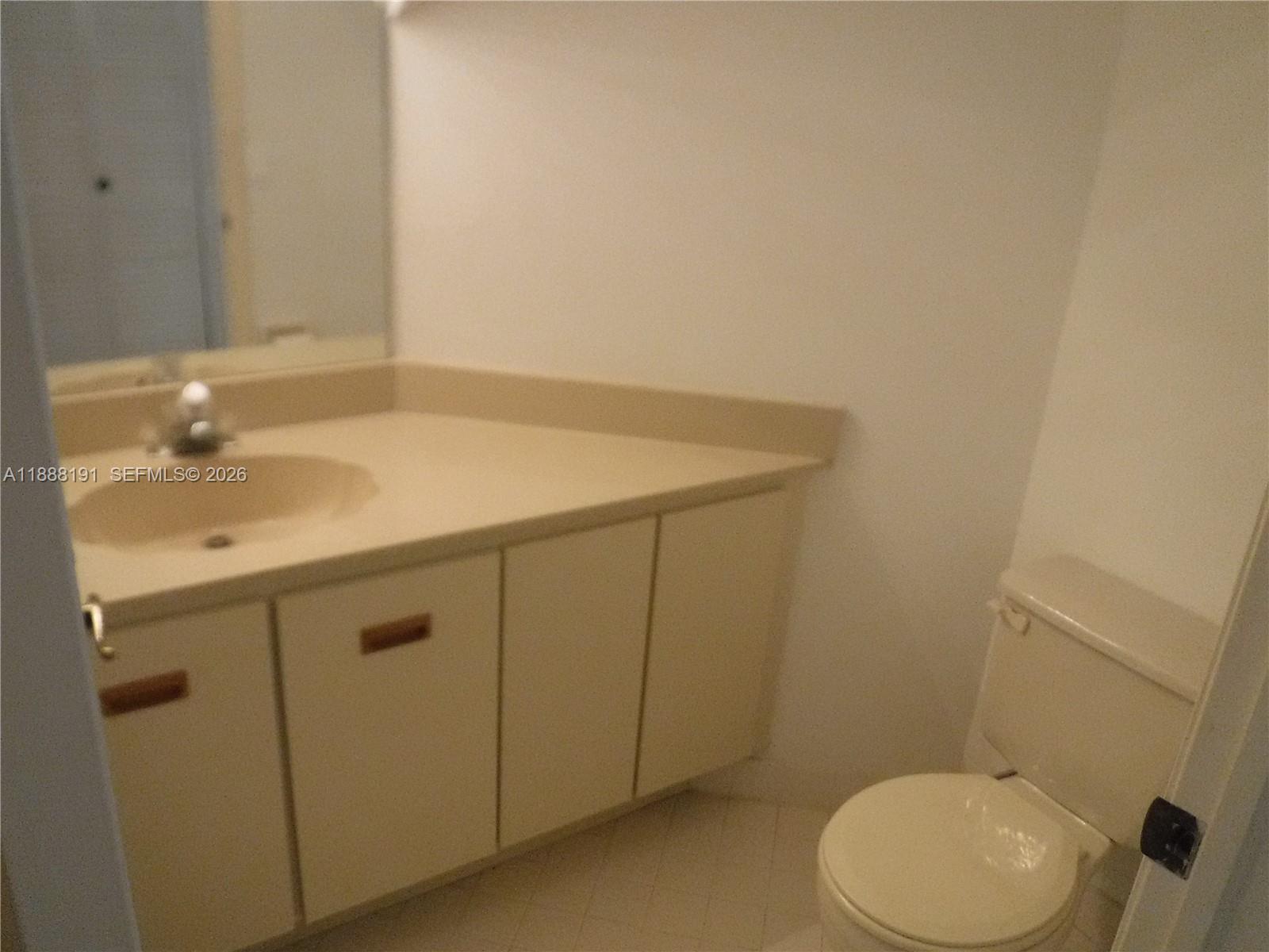 10889 Southwest 149th Place Miami, FL 33196 - Photo 21 of 51 a bathroom with a sink toilet and vanity