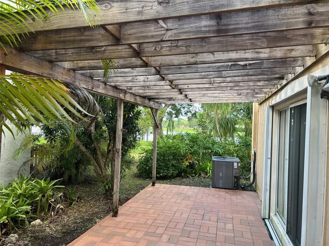 a view of a backyard with plants and outdoor seating