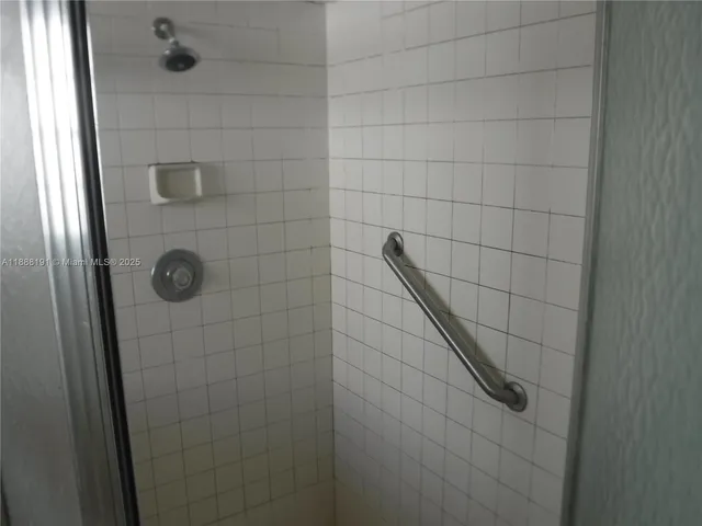 front view of house with a yard and palm trees