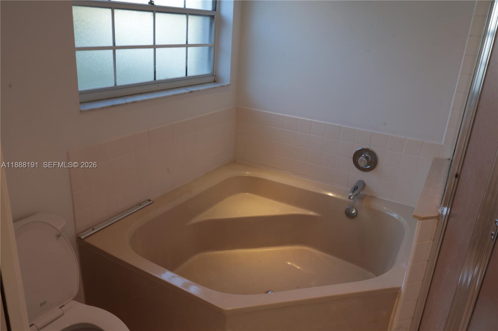 10889 Southwest 149th Place Miami, FL 33196 - Photo 33 of 51 a bath tub sitting in a bathroom next to a window