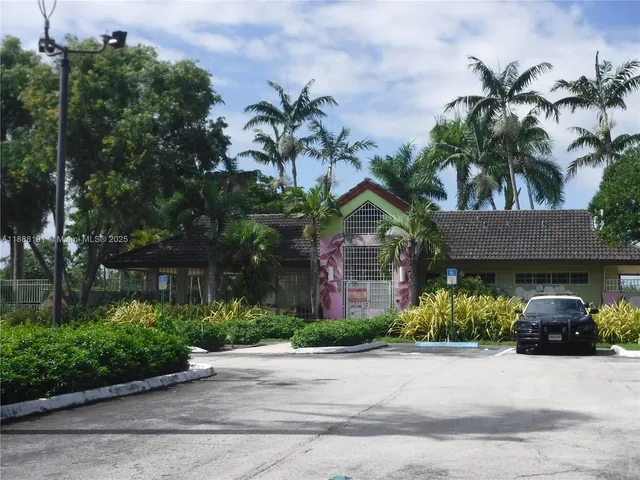 a view of a swimming pool with sitting area and furniture