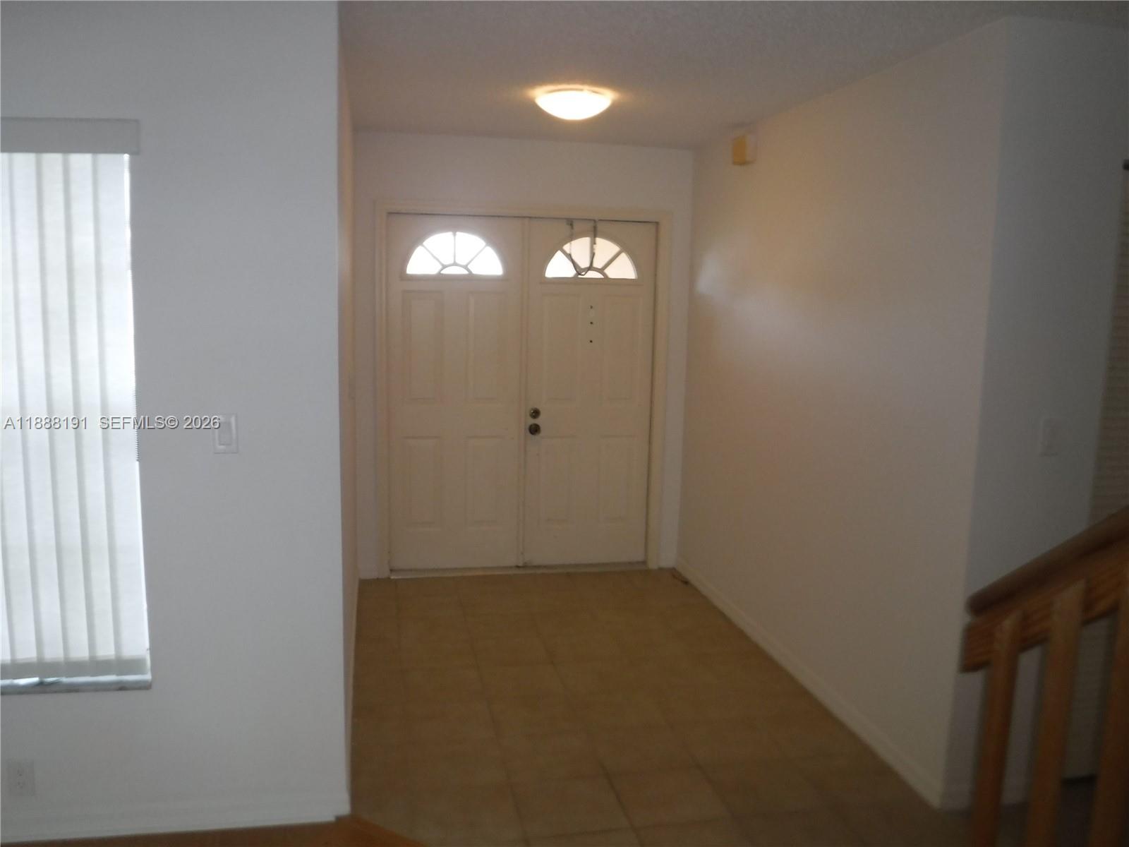10889 Southwest 149th Place Miami, FL 33196 - Photo 10 of 51 an empty room with windows