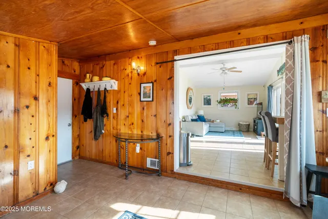 a view of a hallway with kitchen and refrigerator