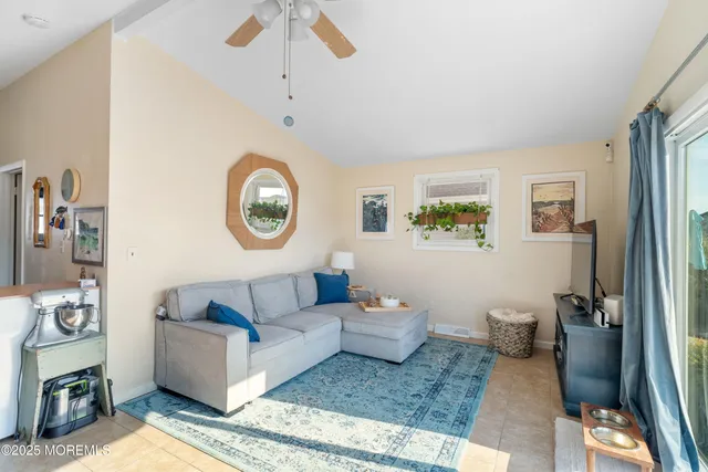 a living room with furniture and a clock