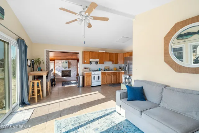 a living room with furniture and a view of kitchen