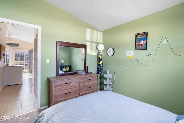 a bedroom with a bed and a mirror