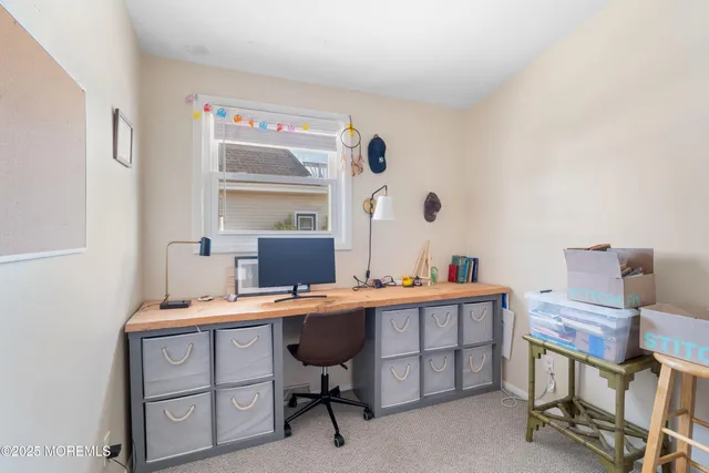 a room with a table chairs and a workspace